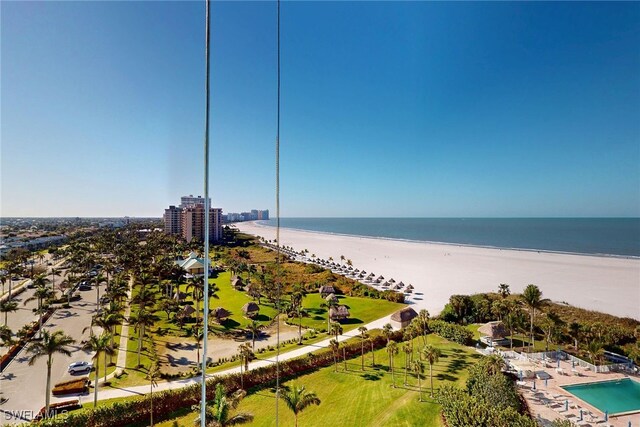 drone / aerial view with a beach view and a water view