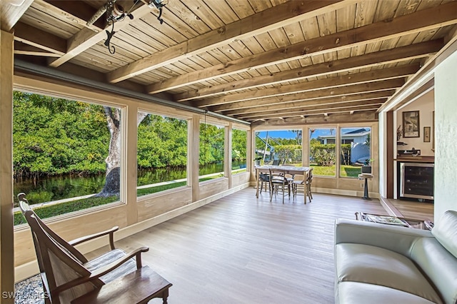 sunroom / solarium featuring wine cooler, beam ceiling, and wooden ceiling