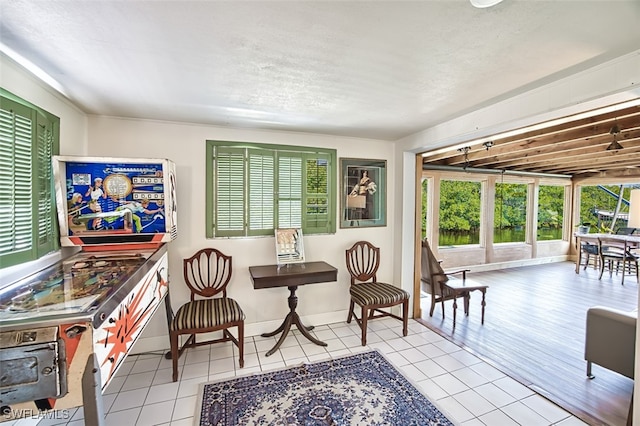 living area with tile patterned floors and baseboards