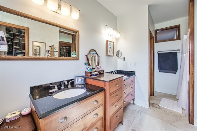 full bathroom featuring marble finish floor, vanity, and baseboards