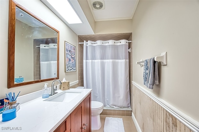 bathroom with tile patterned floors, visible vents, a wainscoted wall, toilet, and a shower stall