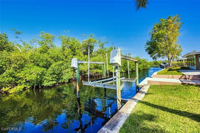 dock area featuring boat lift, a lawn, and a water view