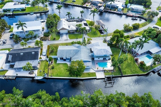 drone / aerial view featuring a residential view and a water view