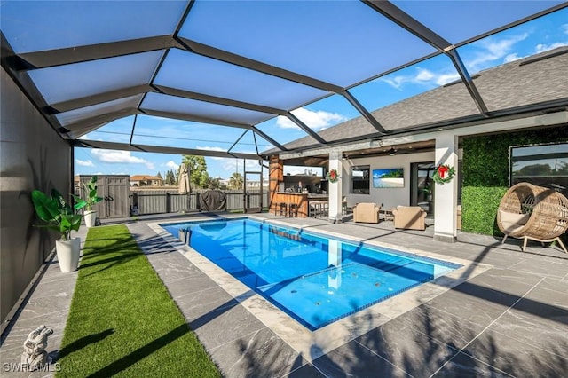 view of pool featuring a patio area, a lanai, a gate, and fence