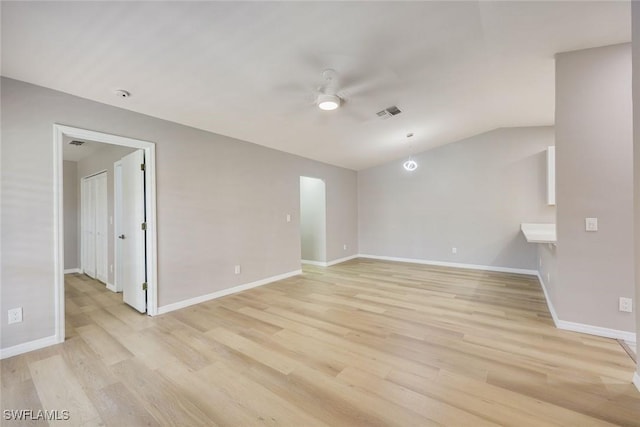 spare room with light wood-style flooring, baseboards, lofted ceiling, and ceiling fan