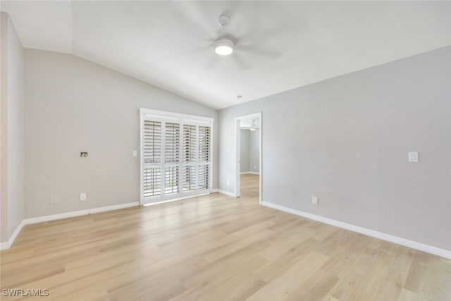 empty room with a ceiling fan, lofted ceiling, light wood-style floors, and baseboards