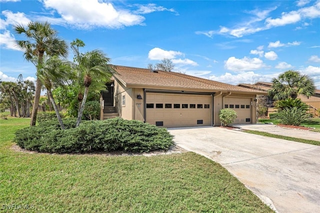 view of front of property with stucco siding, a garage, concrete driveway, and a front yard