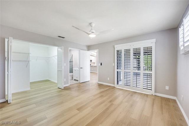 unfurnished bedroom with visible vents, light wood-style flooring, baseboards, and multiple windows