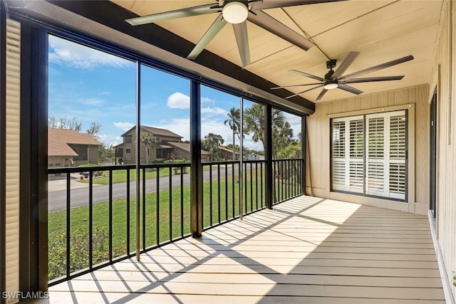 unfurnished sunroom featuring a ceiling fan