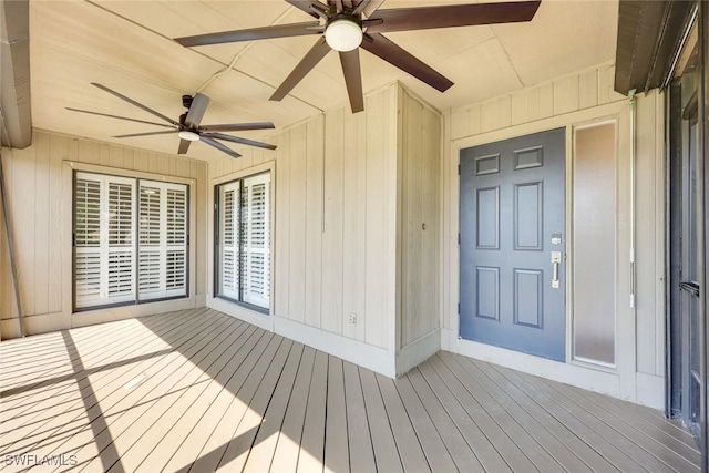 view of exterior entry featuring ceiling fan