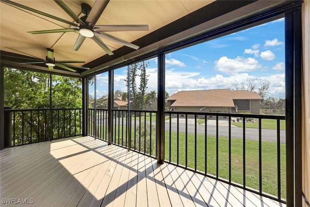 unfurnished sunroom with a healthy amount of sunlight and a ceiling fan