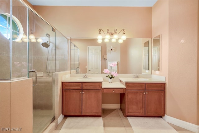 bathroom with vanity, a shower stall, baseboards, and tile patterned floors