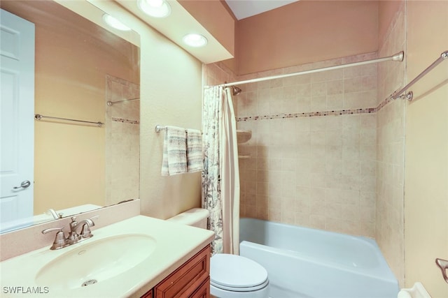 bathroom with vanity, toilet, and shower / bath combo with shower curtain