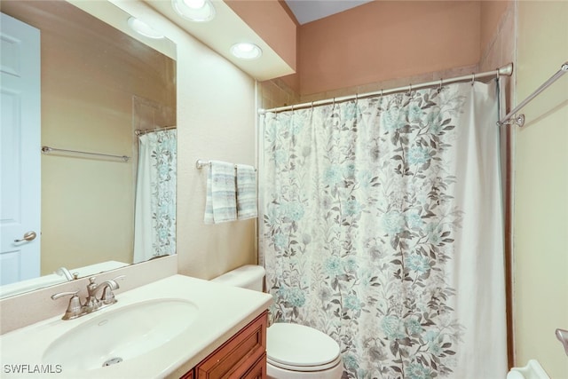 bathroom featuring a shower with shower curtain, toilet, and vanity