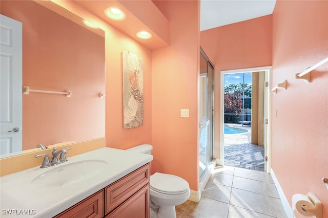 full bath featuring tile patterned floors, toilet, a shower stall, baseboards, and vanity