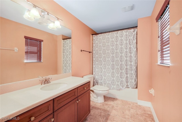 bathroom with baseboards, toilet, vanity, and tile patterned flooring