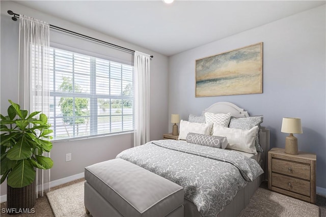 carpeted bedroom with baseboards