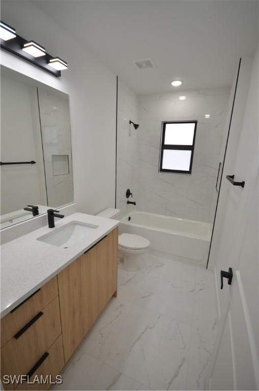 full bathroom with visible vents, toilet, marble finish floor,  shower combination, and vanity