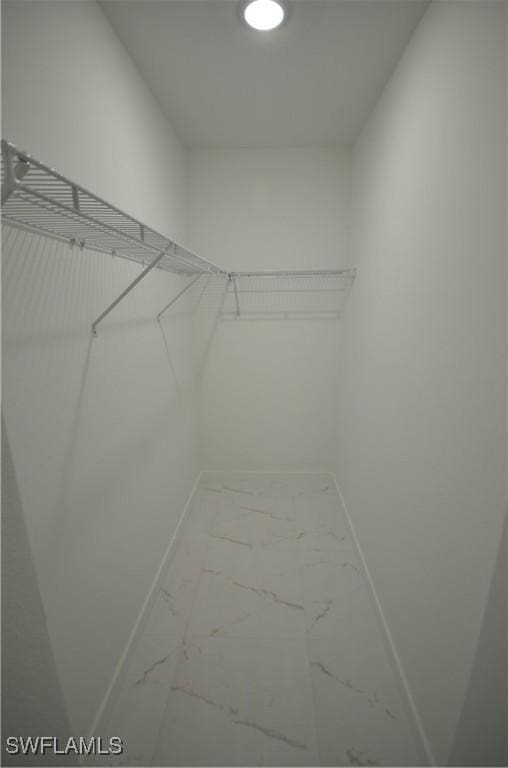 spacious closet with marble finish floor