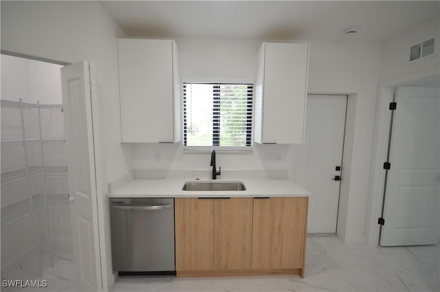 kitchen featuring visible vents, marble finish floor, modern cabinets, a sink, and dishwasher