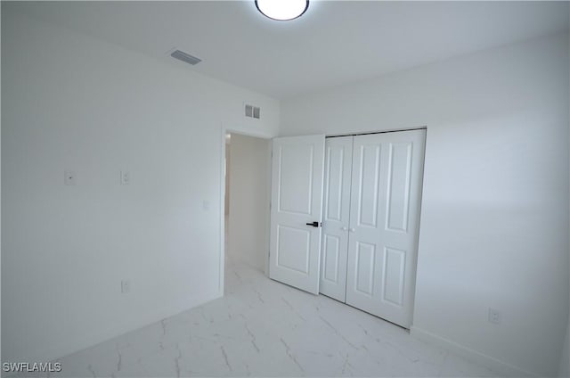 unfurnished bedroom featuring visible vents, marble finish floor, and baseboards