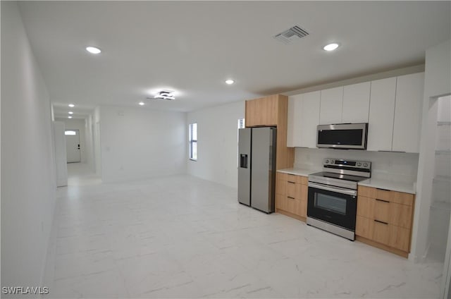 kitchen with visible vents, marble finish floor, stainless steel appliances, and modern cabinets