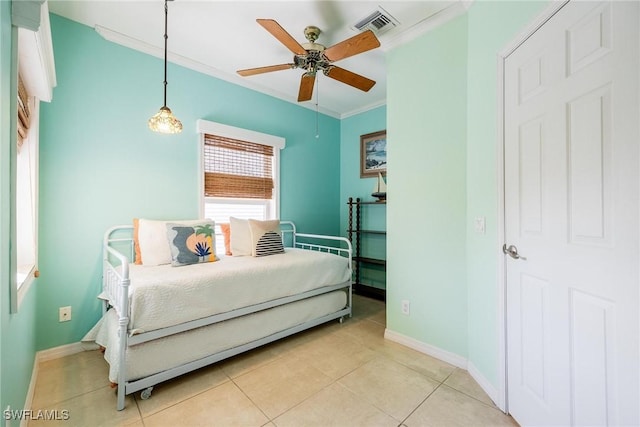 bedroom featuring visible vents, baseboards, light tile patterned flooring, and crown molding