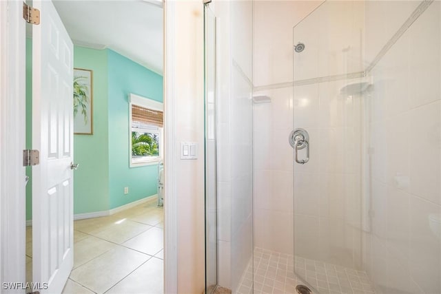 bathroom with tile patterned floors, baseboards, and a stall shower