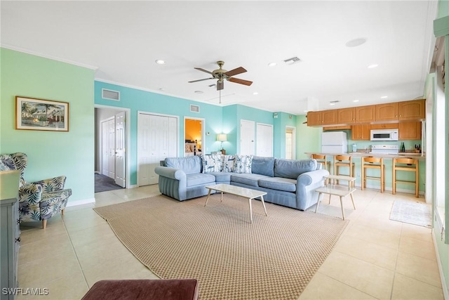 living area featuring visible vents, recessed lighting, crown molding, and baseboards