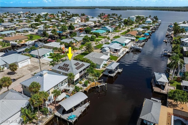 drone / aerial view with a residential view and a water view