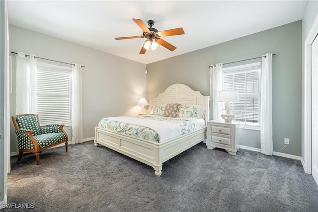 bedroom featuring dark carpet, baseboards, and ceiling fan