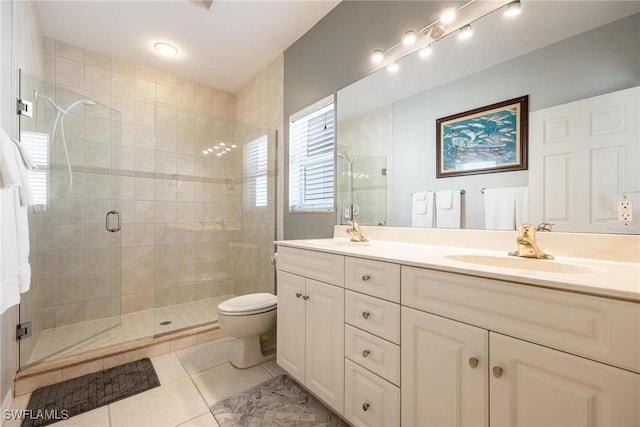 full bathroom with a sink, double vanity, a shower stall, and tile patterned floors