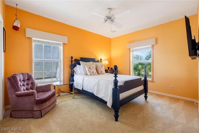 carpeted bedroom featuring a ceiling fan and baseboards