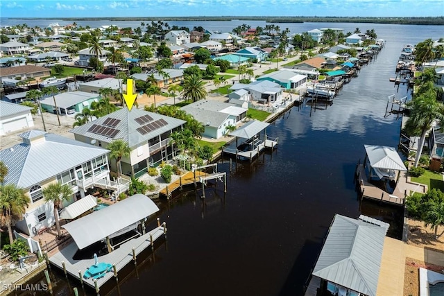 drone / aerial view with a residential view and a water view