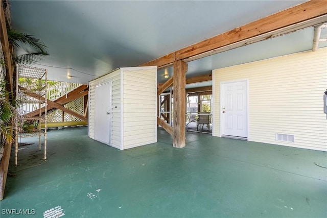 view of patio with visible vents, a storage unit, and an outdoor structure