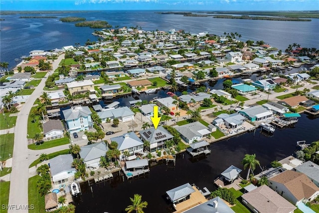 drone / aerial view featuring a residential view and a water view