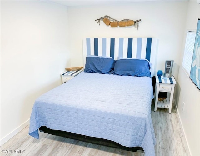 bedroom featuring light wood-style flooring and baseboards