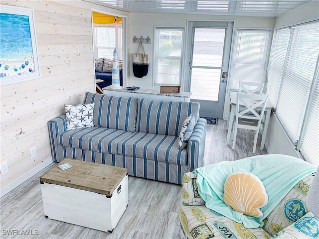 living room featuring wood walls and light wood-type flooring