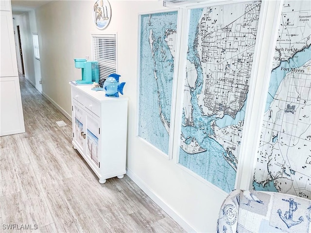 bathroom with baseboards and wood finished floors