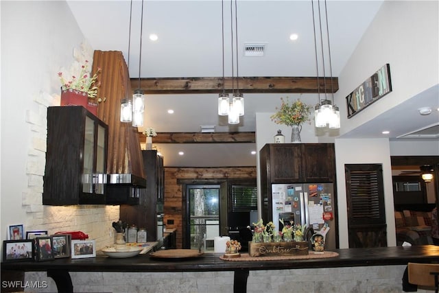 kitchen featuring visible vents, beam ceiling, stainless steel refrigerator with ice dispenser, dark brown cabinets, and ceiling fan