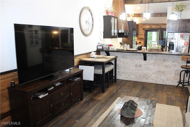 kitchen with dark wood-style floors, decorative backsplash, dark brown cabinets, and stainless steel fridge with ice dispenser