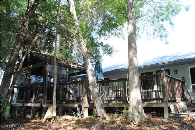 exterior space featuring metal roof and a deck