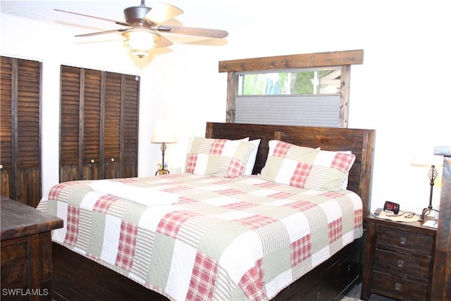 bedroom featuring visible vents, two closets, and a ceiling fan