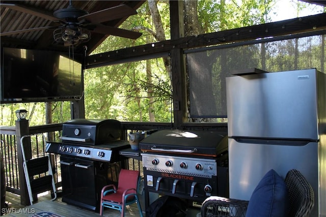 exterior space featuring grilling area and a ceiling fan