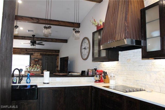 kitchen featuring decorative backsplash, light countertops, black electric stovetop, and a sink