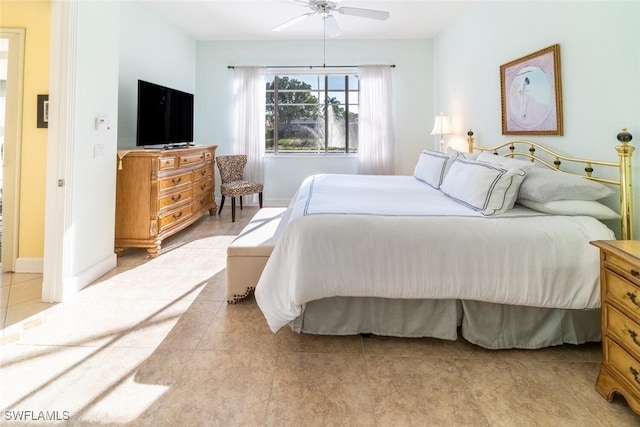 bedroom featuring baseboards, ceiling fan, and light tile patterned flooring