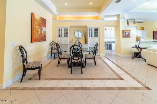 dining room with a raised ceiling, light tile patterned flooring, recessed lighting, and baseboards