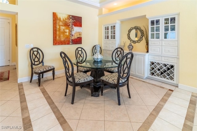 dining area featuring light tile patterned floors, recessed lighting, baseboards, and ornamental molding