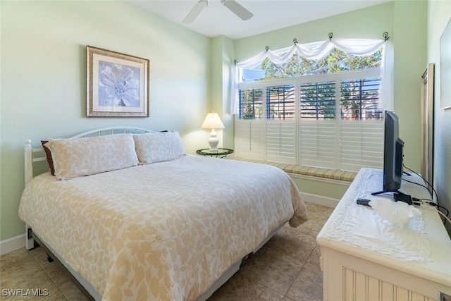 bedroom featuring tile patterned flooring, a ceiling fan, and baseboards