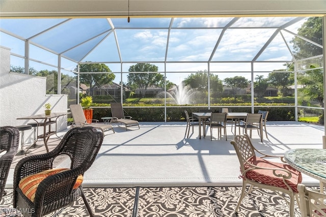 view of patio with glass enclosure